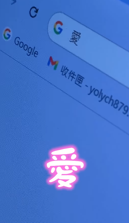 A close photograph of a blue computer screen showing a browser search bar, with the Chinese character 愛 glowing in pink at the centre.